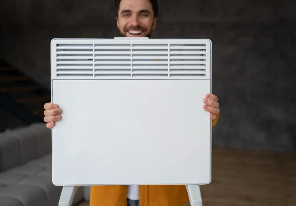 Person holding a clean HVAC air filter unit, showing the front panel before installation.
