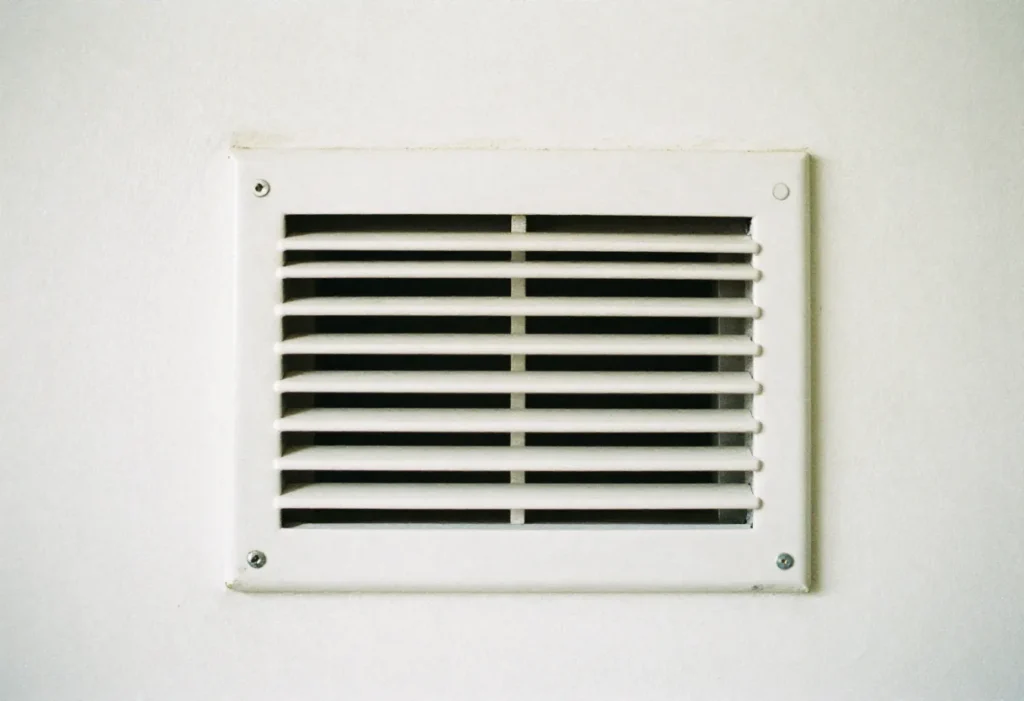 White wall-mounted return air vent grille inside a home