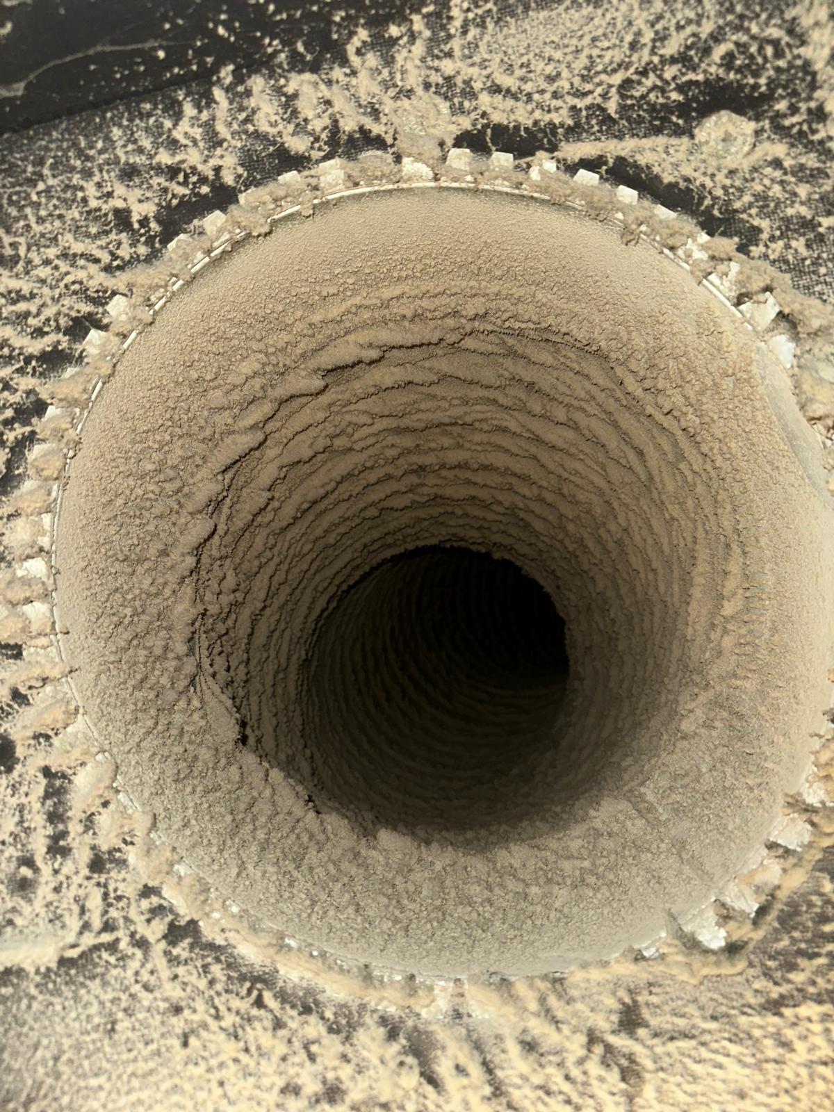 Dust buildup inside an air duct before cleaning in Little Falls, NJ